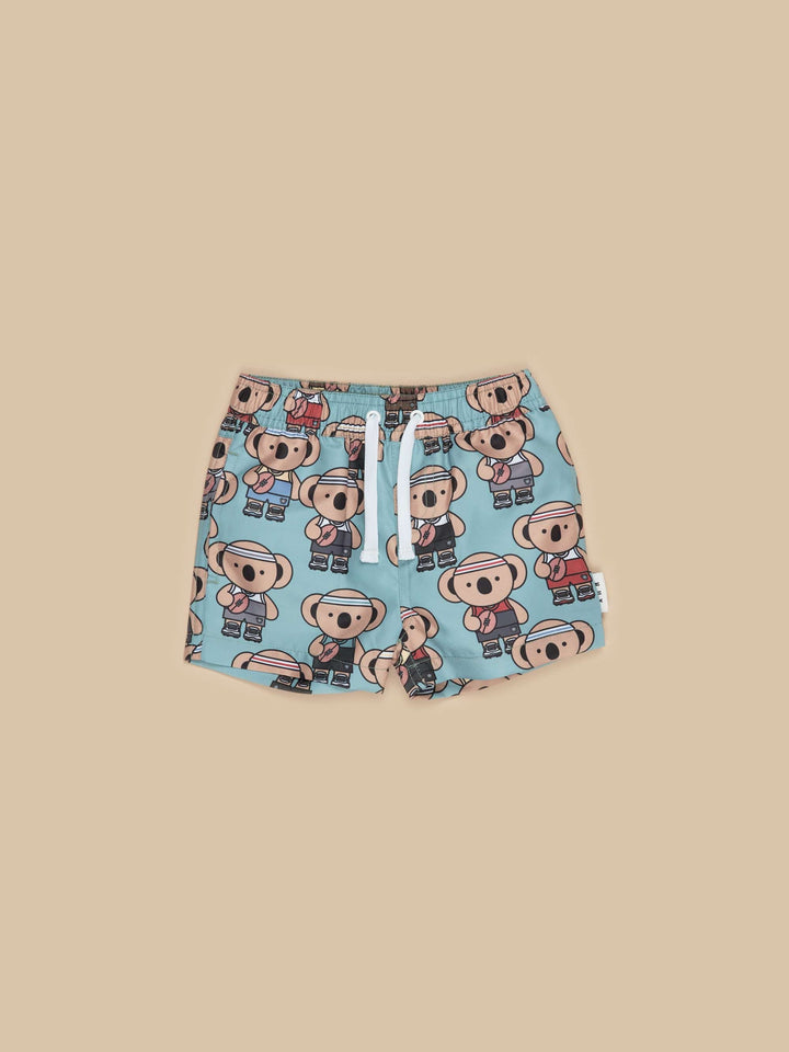 The Sporty Koala Swim Shorts by Huxbaby are the perfect pair of shorts for your little swimmer! Featuring an all over sporty koala print, front pockets and drawstring tie for an adjustable fit.  Made from 100% recycled polyester microfiber, these shorts are comfy and cool all rolled into one!  Made from grs-certified recycled polyester Sustainably produced Safe azo free dyes Wash thoroughly after use/ Warm hand wash Packaged in a 100% recycled LDPE bag Designed in Melbourne, Australia by Huxbaby
