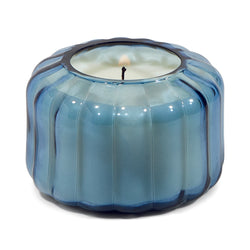 The Indigo Small Ribbed Glass Candle by Paddywax is designed to elevate tablescapes.   Bring a vintage touch to your next dinner party with these subtle and finely ribbed coloured glass vessels, available in both small and large sizes.  With a focus on sustainability, a repurposing tip is to try using the vessel as a votive for tea lights.  Top Notes: Peppered Woods  Middle Notes: Fern Leaf, Spiced Citrus  Base Notes: Oriental Musk