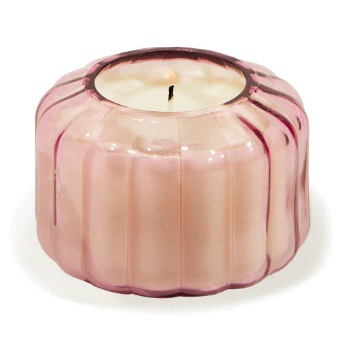 The Desert Peach Small Ribbed Glass Candle by Paddywax is designed to elevate tablescapes.   Bring a vintage touch to your next dinner party with the subtle and finely ribbed coloured glass vessels, available in both small and large sizes.  With a focus on sustainability, a repurposing tip is to try using the vessel as a votive for tea lights.  Top Notes: Peach, Bergamot, Cassis Buds, Pineapple Middle Notes: Neroli, Linden Blossom, Plum, Sweet Base Notes: Amber, Lactonic, Coconut, Sweet