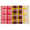Plaid patterned rug with pink, yellow, and brown colors on a white background. 