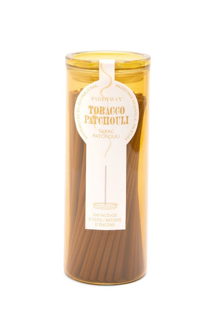 Meet the new incense collection from Paddywax. Featuring some of their most popular fragrances, these Tobacco Patchouli Incense Sticks deliver both incense and an incense holder all in one beautifully designed coloured glass vessel.  Top Notes: Cinnamon, Nutmeg Middle Notes: Patchouli, Vetiver Base Notes: Tobacco, Sandalwood, Creamy Vanilla