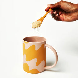 Drink your hot beverage in style with the Pink Waves Happy Mug by Jones & Co, which features undulating, free-form waves in a dusky pink and mustard pattern.  This standout mug has a hand-painted matte finish and is lined on the interior with a glossy glaze. There's also a generously proportioned handle for comfortable sipping.   *Dimensions- Length: 8cm/ Width: 8cm / Height: 11cm *Microwave and dishwasher safe *Designed in Sydney, Australia by Jones & Co *Hand-crafted in Vietnam by local artisans